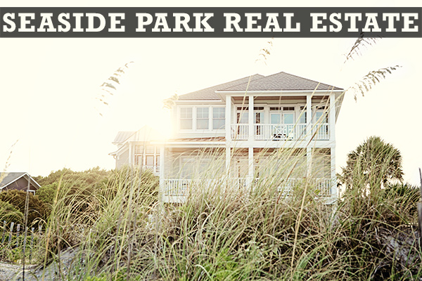 Seaside Park Real Estate in bold font on the top of a picture of a beach house backlit by a setting sun with beach grasses in the foreground