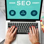 "SEO Ocean County" in white font on teal screen on laptop